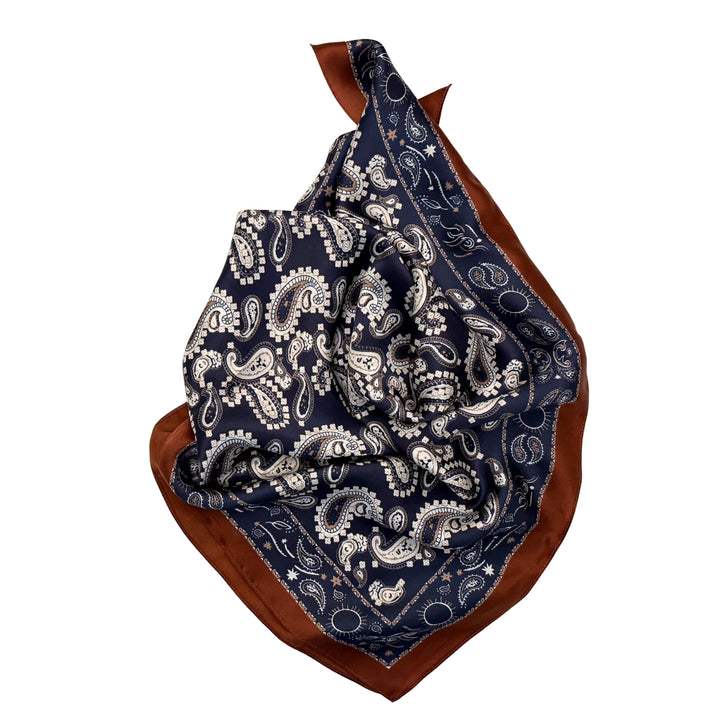 Paisley silk scarf neatly folded showing the detailed paisley design and copper edge.
