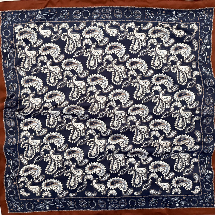 White, beige and navy paisley silk scarf with copper edge shown in full top view.