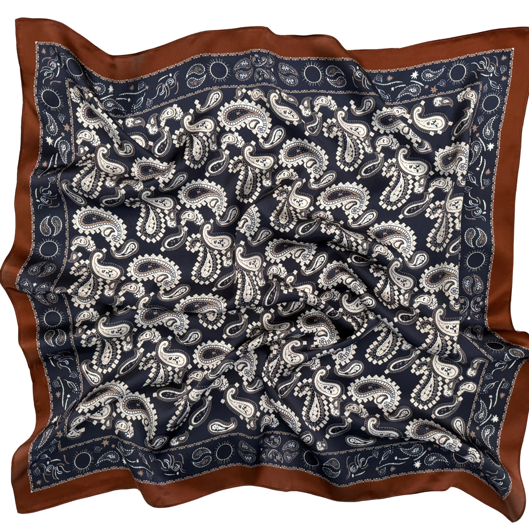 Paisley silk scarf softly laid out in a relaxed arrangement.