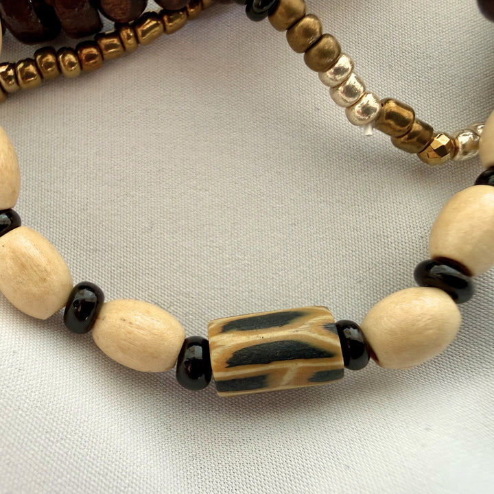 Close-up of wood beads combined with patterned polymer clay beads on a handcrafted bracelet.